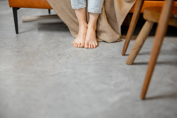 istock Woman's legs on the floor while she working with laptop 1303138273