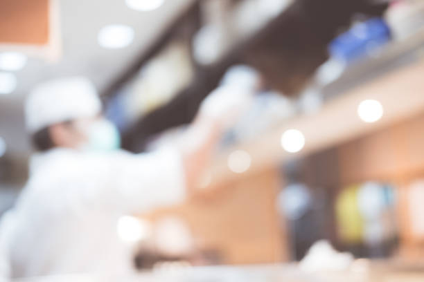 istock Japanese chef cooking in restaurant kitchen abstract blurred defocused background 1303138347