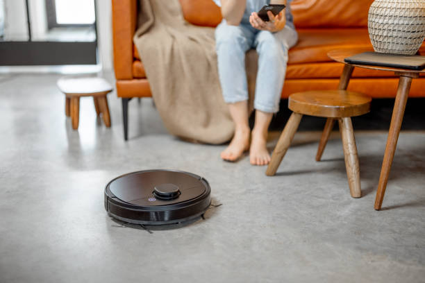 istock Robotic vacuum cleaner cleaning the room at home 1303138519