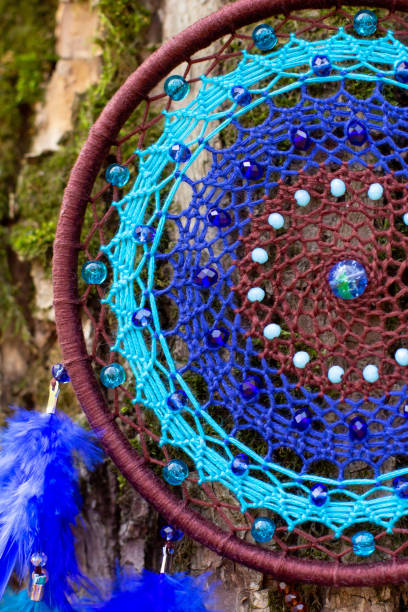 istock Handmade dream catcher with feathers threads and beads rope hanging 1303139964