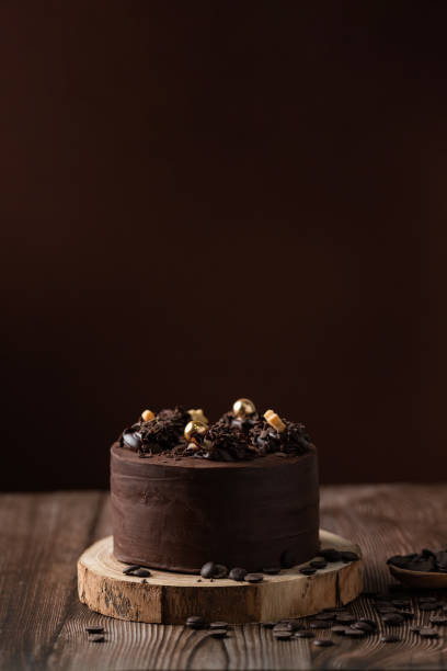 istock front view of chocolate cake, with chocolate chips, spoon and wooden table. 1303139989
