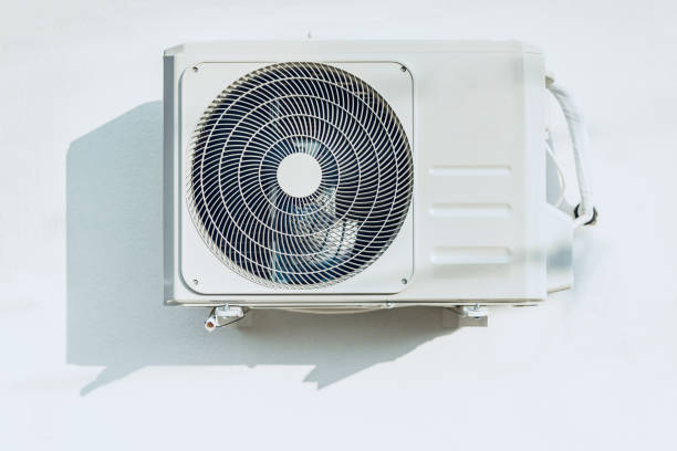 New outside air conditioner unit hanging on white wall New outside air conditioner unit hanging on white wall, front view pump dress shoe stock pictures, royalty-free photos & images