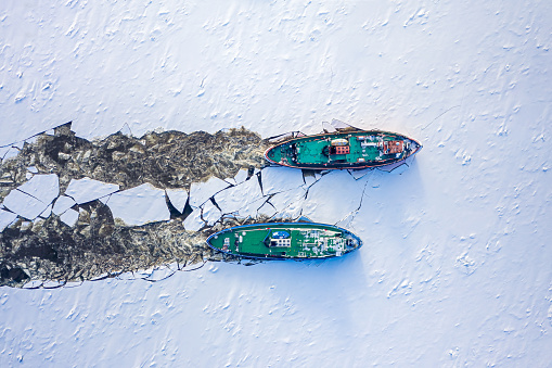 Two icebreakers breaking ce on Vistula river, Poland, 2020-02-18, aerial view