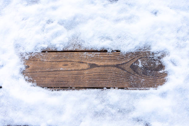 istock Winter background. Empty wooden plank with snow border, copy space for text 1303141310