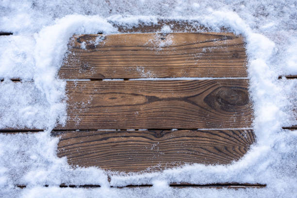 istock Winter background. Empty wooden plank with snow border, copy space for text 1303141313