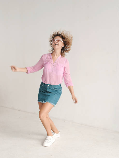 istock Smiling curly hair woman in dance studio 1303141317