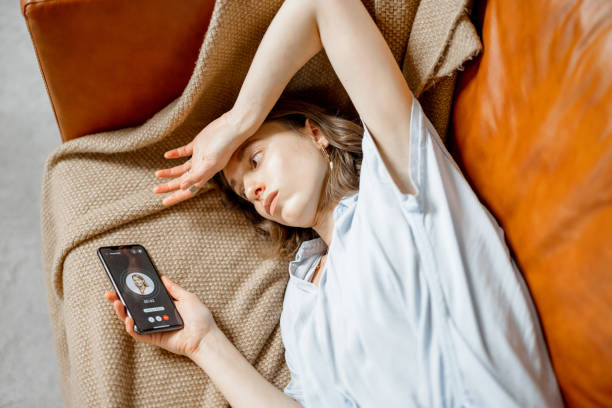 istock Woman feel bad lying on sofa and call a doctor 1303142809