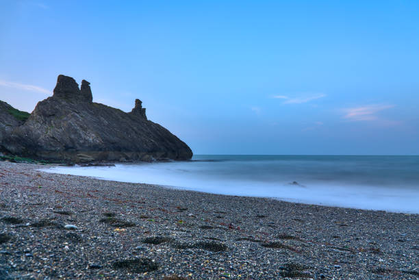 Long exposure low ground close up view of seascape and Black Castle ruins stock photo