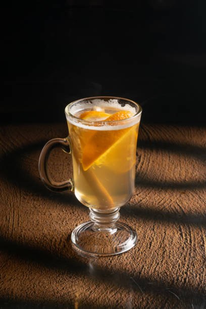istock Hot ginger tea with orange and cinnamon in a clear glass 1303143559