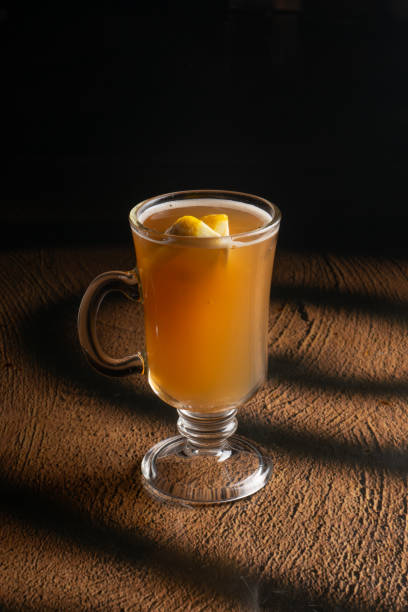 istock Hot fruit tea with orange and honey in a clear glass 1303143580