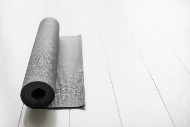 istock Exercise mat on a wooden floor, preparing doing yoga or workout 1303143656