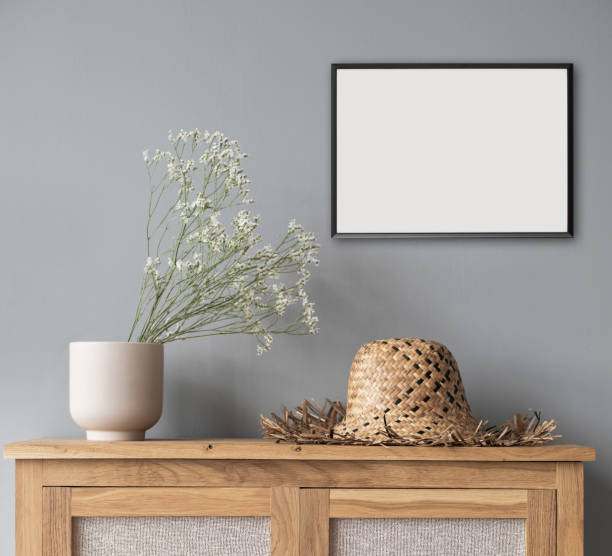 istock Small blank picture frame mockup on white wall. Living room or bedroom design 1303144330
