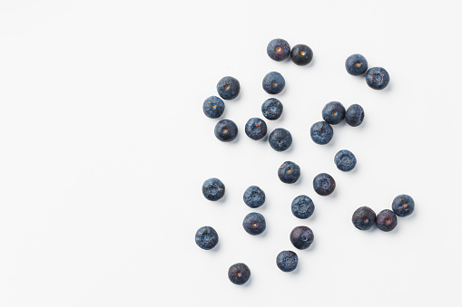 Top view of fresh blueberries on white background, flat lay