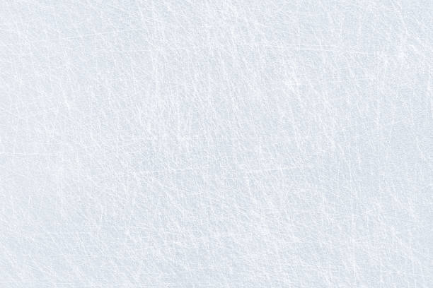Photo of Ice background texture and snow surface with marks and lines from skating. Ice hockey rink, arena or stadium from top view. Light blue frost wallpaper. Rough frosty traces from winter sport.