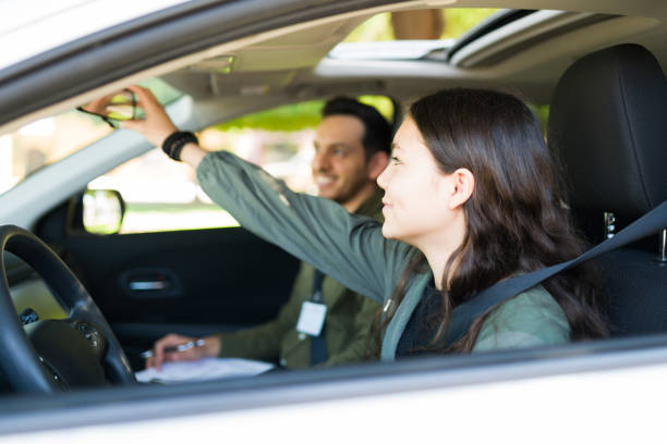 istock Caucasian adolescent girl starting her driving exam 1303145765