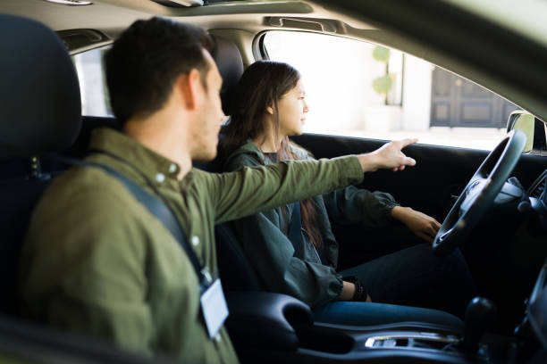istock Adolescent girl taking her driver's license practice test 1303145769