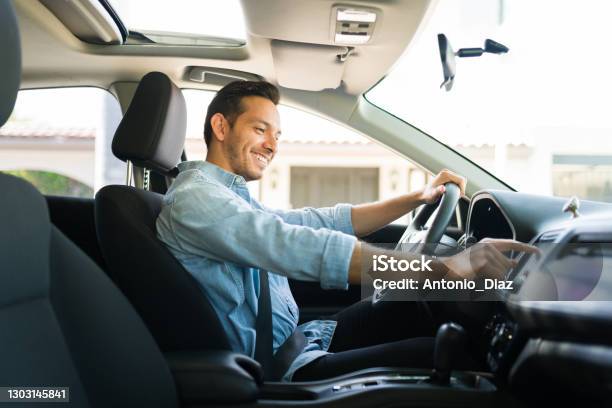 Attractive Male Driver Using The Gps Navigation Map On The Car Stock Photo - Download Image Now