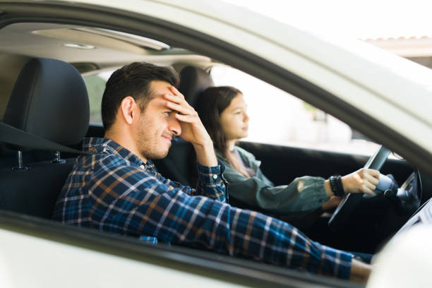istock Teenage girl practicing driving with her stressed dad 1303145914