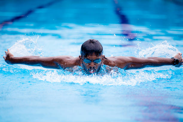 istock Asian Indian swimmer practicing in swimming pool with butterfly style 1303146626