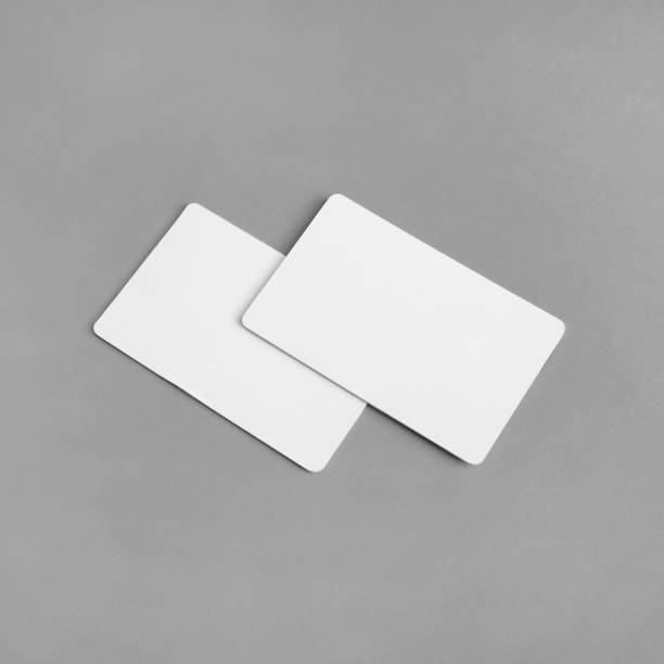 Two business cards Photo of two blank white business cards on gray paper background. Branding ID template. square business card mockup stock pictures, royalty-free photos & images