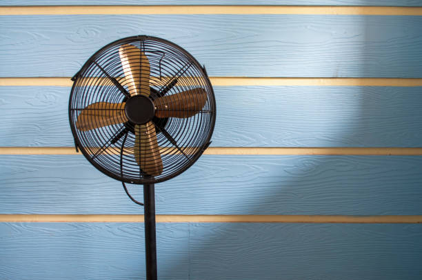 istock Black old fan on a blue background 1303152236