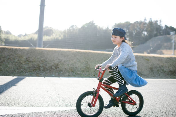 istock Girl playing on a bicycle 1303152286