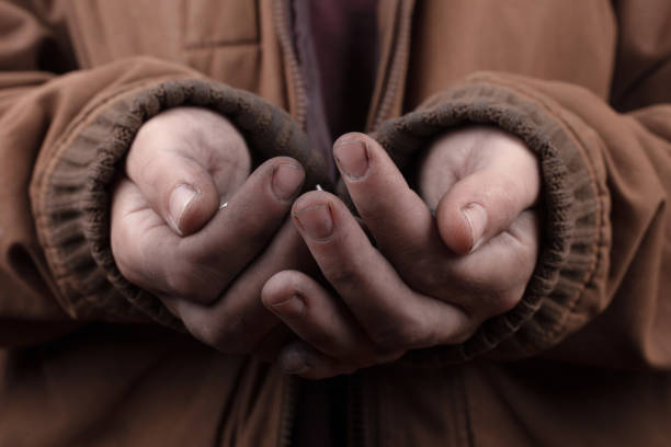 istock homeless poor beggar asks for help ,unemployed in despair. 1303153117
