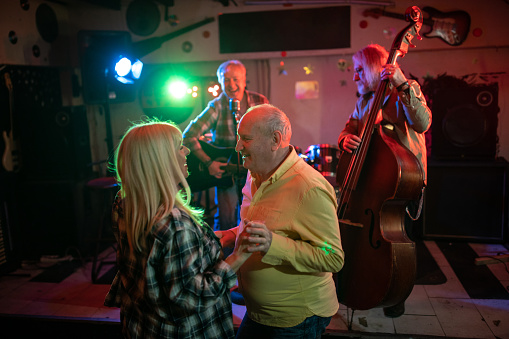 Lovely senior couple showing their dance moves on dance floor during date night