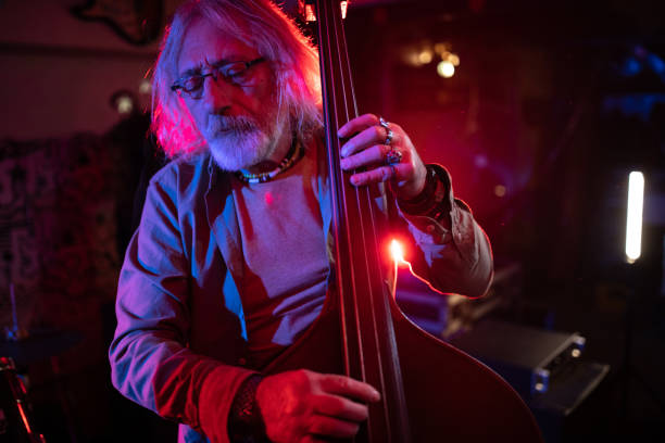 istock Senior double bass player enjoying the feeling when he performing on stage 1303156668