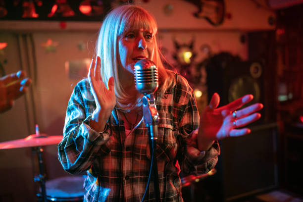 istock Singer having a performance with her band on stage 1303156675