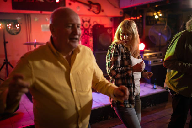 istock Senior friends having fun dancing together on dance floor 1303156687
