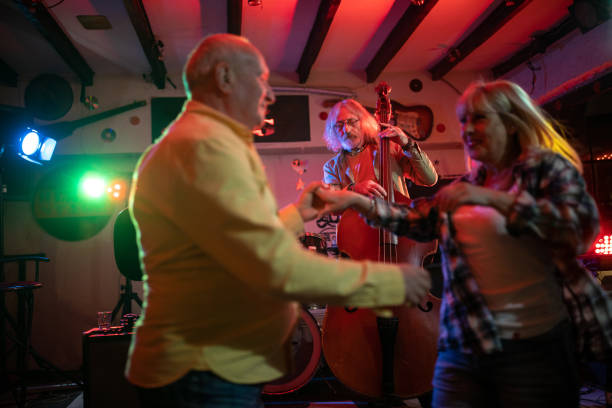 istock Band playing music while senior couple dancing on dance floor 1303156691