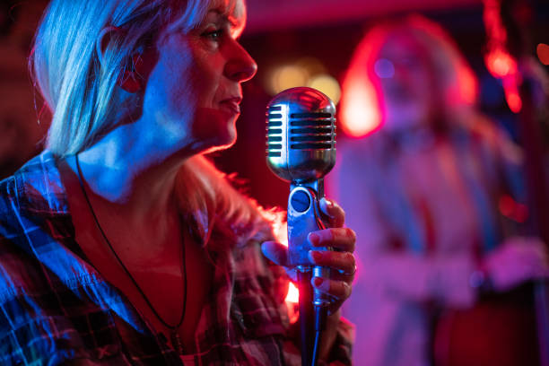 istock Singer having a performance with her band on stage 1303156942