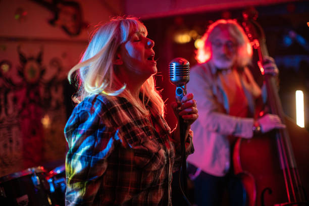 istock Singer having a performance with her band on stage 1303156987