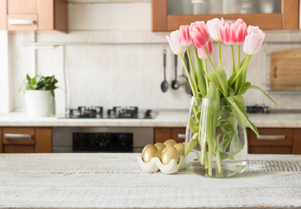 istock Easter golden painted eggs and spring bouquet in kitchen. 1303157933