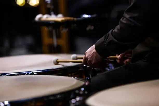 Photo of Hands of a musician playing the timpani