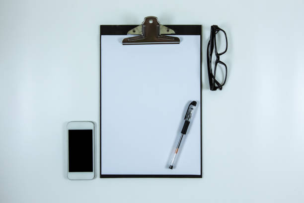 istock Clipboard and smartphone on white background. 1303164052