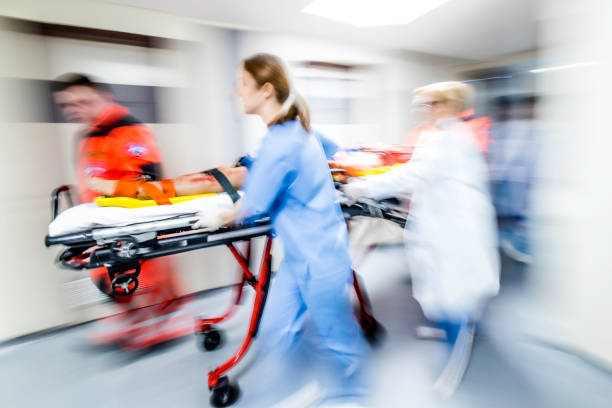 istock Paramedic and hospital staff quickly wheeling stretcher with patient 1303165246