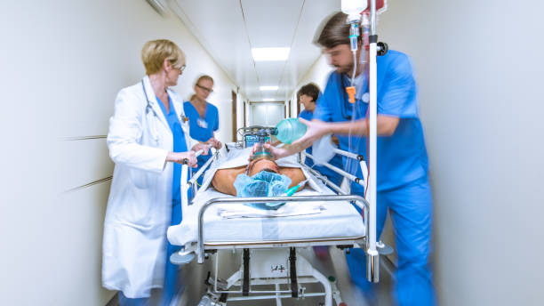 istock Doctor and nurses wheeling patient in gurney 1303165297