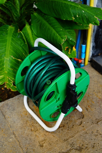 green hose roller in garden