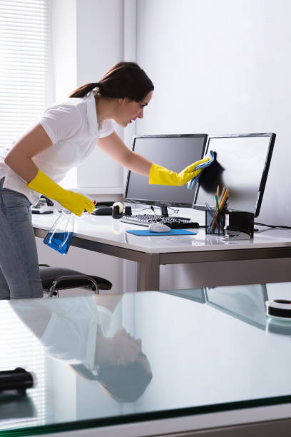 istock Woman Cleaning Computer In Office 1303166914