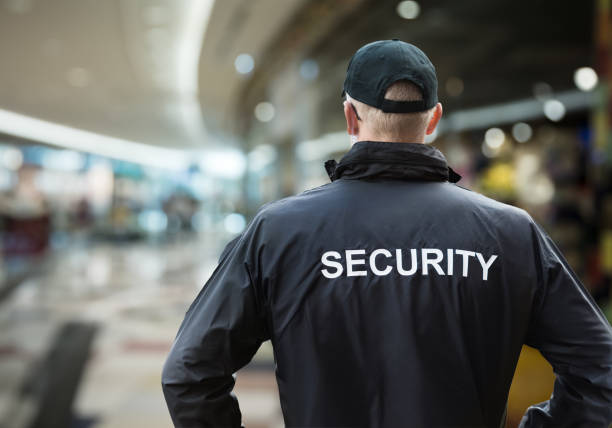 Security Man Looking At Moscow Kremlin And St Basil's Cathedral Security Man Looking At Moscow Kremlin On The Red Square In Moscow security staff stock pictures, royalty-free photos & images