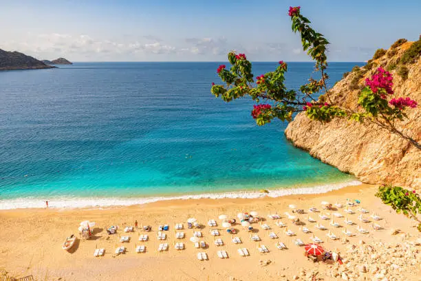 Kaputas beach in Antalya region, Turkey with clear turquoise water, sun umbrellas and sandy beach. Holiday or vacation resort