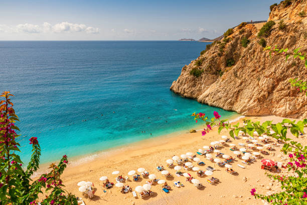 plage de kaputas avec l’eau bleue sur la côte de la région d’antalya en turquie avec des parapluies de soleil sur la plage - kas photos et images de collection