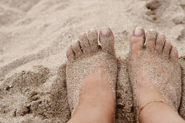 istock Female feet in sea. 1303168990