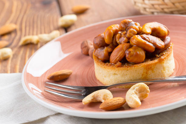 istock Tart with nuts on pink plate close up 1303169363