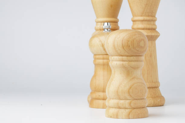 istock Wooden mills with salt and pepper on white 1303170226