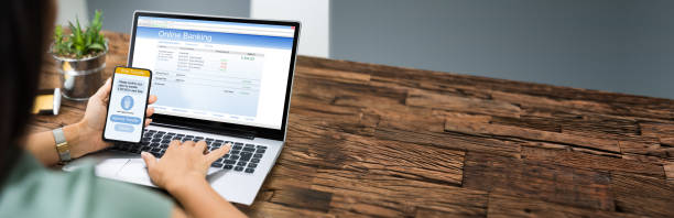 istock Woman Using Mobile Phone App To Authenthificate Bank Transfer 1303170692