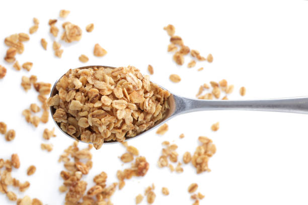 istock Heap of granola oats on a spoon selective focus 1303173408