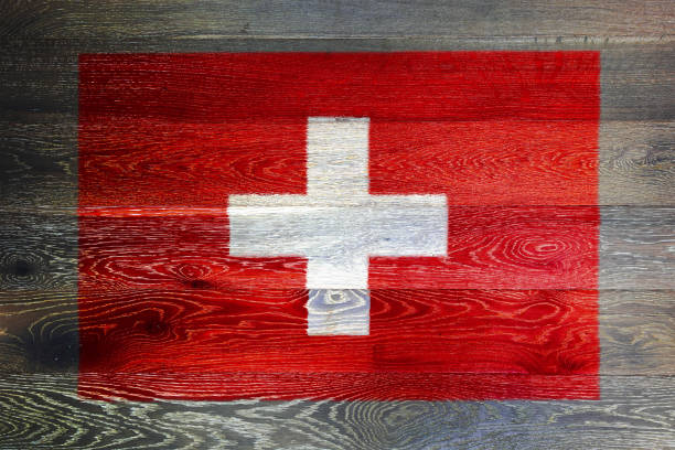 istock Switzerland flag on rustic old wood surface background 1303173415